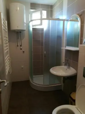 a bathroom with a glass shower and a sink at Appartement Kopaonik in Raška