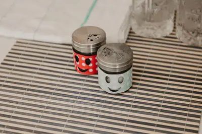 two jars with faces on them sitting on a shelf at Apartman ELEVEN in Kraljevo