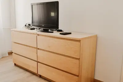 a tv sitting on top of a dresser at Apartman ELEVEN in Kraljevo