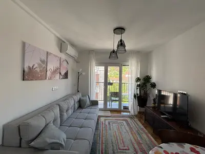 a living room with a couch and a television at Apartman Mirka, Vrnjačka Banja in Vrnjačka Banja