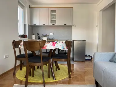 a kitchen with a table and chairs in a room at Apartman Mirka, Vrnjačka Banja in Vrnjačka Banja