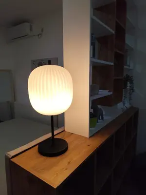 a lamp sitting on top of a wooden table at Bili Prestige Lux in Paraćin