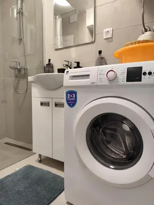 a washing machine in a bathroom with a sink at Bili Prestige Lux in Paraćin