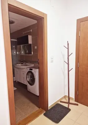 a kitchen with a washing machine in a room at See U in Pegaz in Vrnjačka Banja