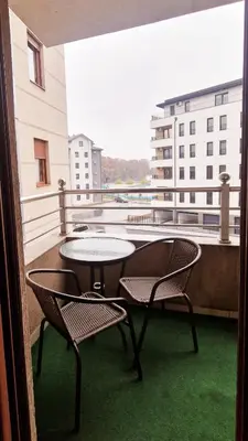 a balcony with two chairs and a table on a balcony at See U in Pegaz in Vrnjačka Banja