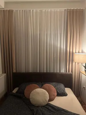 a bedroom with a bed with two pillows on it at Apartman Golden Crown in Vranje