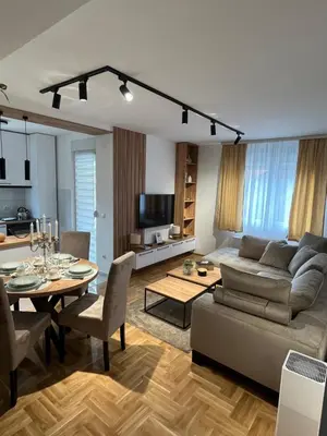 a living room with a couch and a table at Apartman TiHana in Pirot