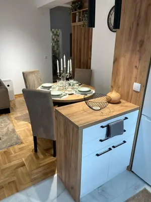 a dining room with a table with a dining room gmaxwell gmaxwell gmaxwell at Apartman TiHana in Pirot