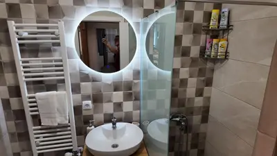 a bathroom with a sink and a mirror at Apartman TiHana in Pirot