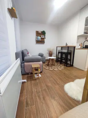 a living room with a couch and a table at Zvuk Treske in Kopaonik