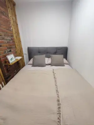 a bed with two pillows in a room at Zvuk Treske in Kopaonik