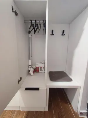 a kitchen with a white cupboard with utensils at Zvuk Treske in Kopaonik