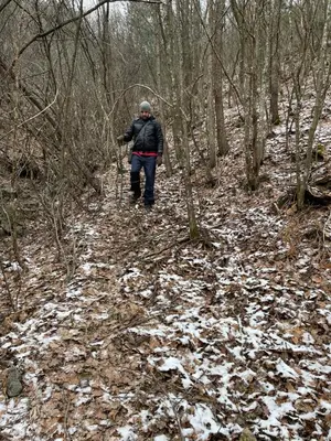 a person walking on a trail in the woods at Borjak vikendica in Kamenica