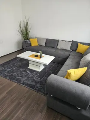 a living room with a couch and a coffee table at Ivys apartman in Ćuprija