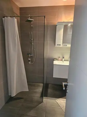 a bathroom with a shower and a sink at Ivys apartman in Ćuprija