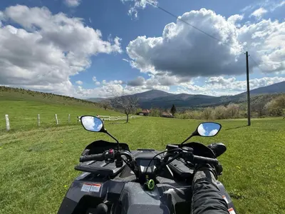 a person is riding a motorcycle in a field at Rose casa apartments Vrnjacka Banja in Vrnjci