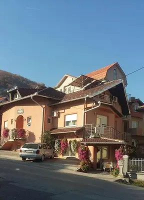 a house with a car parked in front of it at Vila Aleksandra 1 Sokobanja in Soko Banja