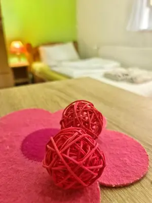 a ball of red yarn sitting on top of a bed at Vila Aleksandra 1 Sokobanja in Soko Banja