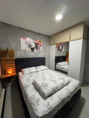 a bedroom with a large bed and a mirror at Apartman ViR in Soko Banja