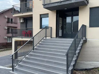 a stairway leading up to a building with glass doors at Apartman ViR in Soko Banja