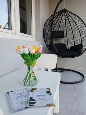 a vase of tulips sitting on a table at Vila Bela in Soko Banja