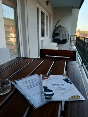 a book sitting on top of a wooden table at Vila Bela in Soko Banja