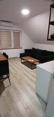 a living room with a couch and a table at Vila Bela in Soko Banja
