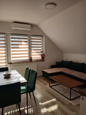 a living room with a couch and a table at Vila Bela in Soko Banja