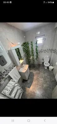 a bathroom with two toilets and a sink and a sink at Vila Bela in Soko Banja