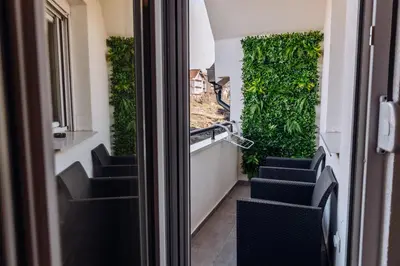 a stairway with green walls and blue stairs at Apartman Pavlović Lux in Soko Banja