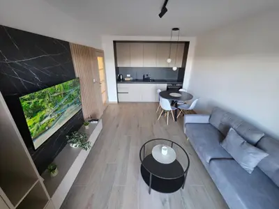 a living room with a blue couch and a table at Apartmani Central A20 & Free parking in Vrnjci