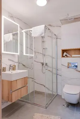 a bathroom with a glass shower and a toilet at Apartmani Central A11 & Free parking in Vrnjci