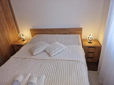 a bedroom with a bed with two pillows on it at Apartman Miha Vrnjačka Banja in Vrnjci