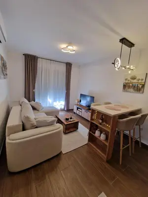 a living room with a couch and a table at Apartman Miha Vrnjačka Banja in Vrnjci