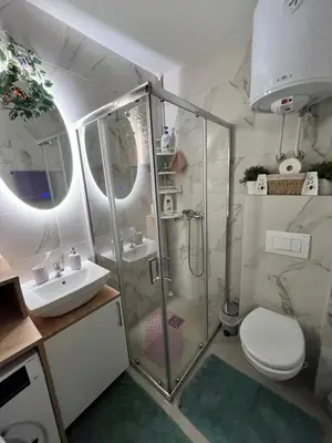 a bathroom with a shower and a toilet and a sink at Mk Lux Apartman in Soko Banja
