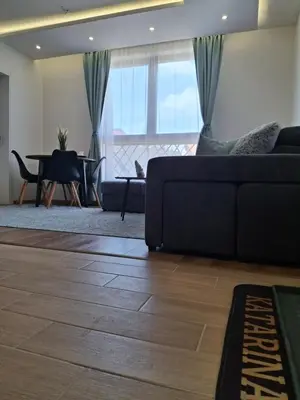 a living room with a couch and a table at Kopaonik-President kop APP Katarina- free wellness&spa in Kopaonik