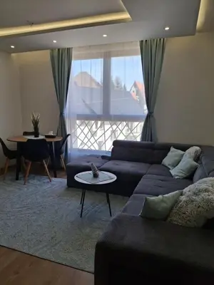a living room with a couch and a table at Kopaonik-President kop APP Katarina- free wellness&spa in Kopaonik