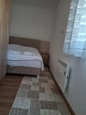 a small bedroom with a bed and a window at Kopaonik-President kop APP Katarina- free wellness&spa in Kopaonik