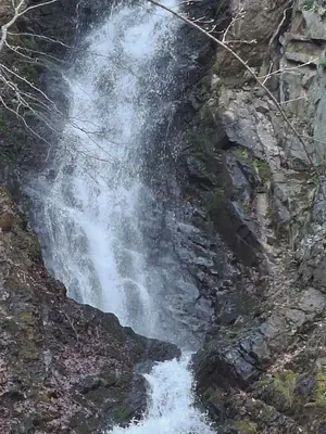 a waterfall on the side of a rocky cliff at Kopaonik-President kop APP Katarina- free wellness&spa in Kopaonik