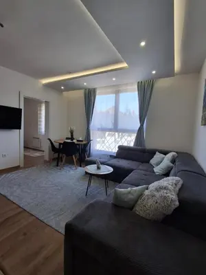 a living room with a couch and a table at Kopaonik-President kop APP Katarina- free wellness&spa in Kopaonik