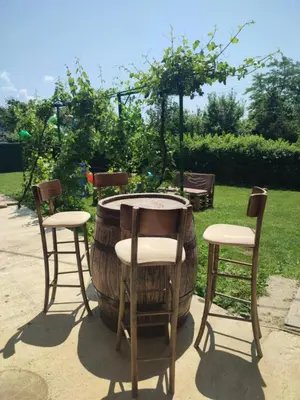 a table and two chairs and a large barrel at Vikendica i apartman HS in Pirot