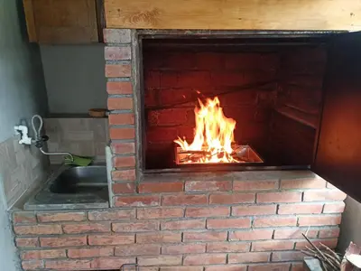 a brick oven with a fire in it at Vikendica i apartman HS in Pirot