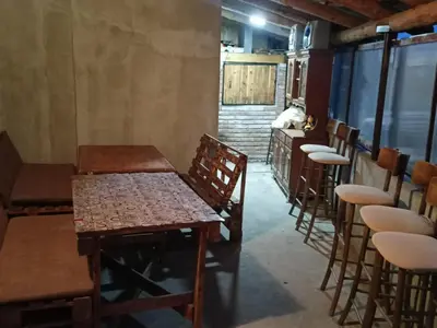 a row of tables and chairs in a room at Vikendica i apartman HS in Pirot