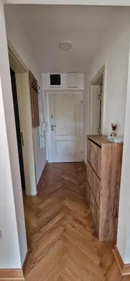 an empty room with a hallway with a wooden floor at Apartman Vera in Vrnjačka Banja