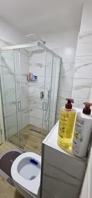 a bathroom with a toilet and a glass shower at Apartman Vera in Vrnjačka Banja