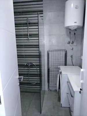 a bathroom with a shower and a sink at Apartman TRI PRINCEZE in Soko Banja