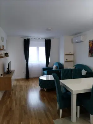 a living room with a couch and a table at Apartman TRI PRINCEZE in Soko Banja