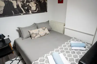 a bedroom with a bed with pillows on it at Apartman Maja in Niš