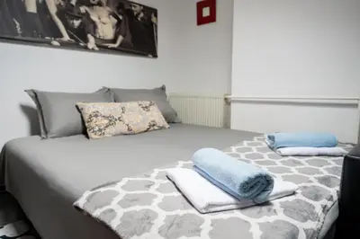 a bedroom with a bed with towels on it at Apartman Maja in Niš