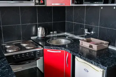 a kitchen with a stove and a sink at Apartman Maja in Niš